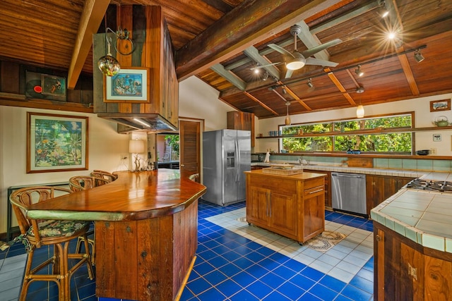7315 Alealea Rd, Hanalei, HI 96714 - kitchen with stainless steel appliances, rail lighting, wooden ceiling, tile counters, and a ceiling fan