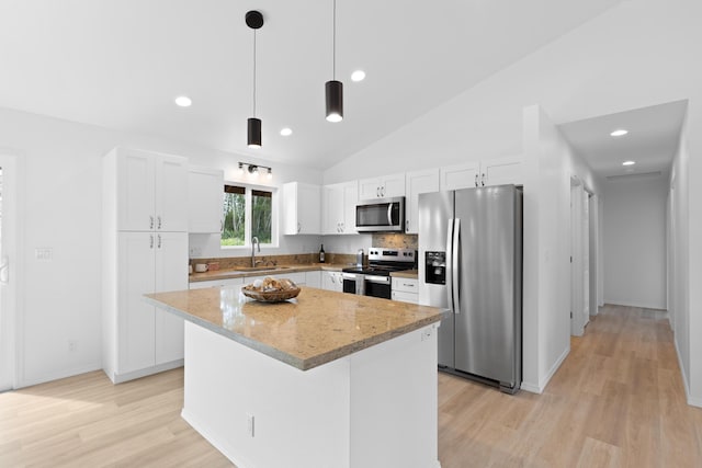 16-2072 Hapuu Dr, Pahoa, HI 96778 - kitchen with stainless steel appliances, a sink, light wood finished floors, white cabinetry, and a center island