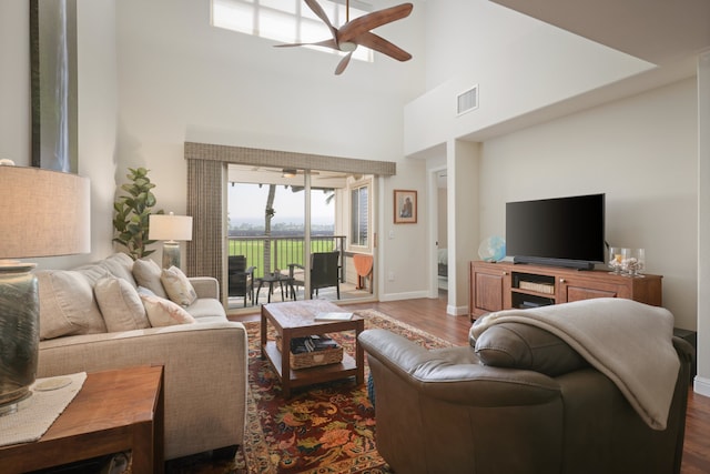 68-1122 Na Ala Hele Rd Unit A22, Kamuela, HI 96743 - living room featuring ceiling fan, a high ceiling, dark wood finished floors, and baseboards