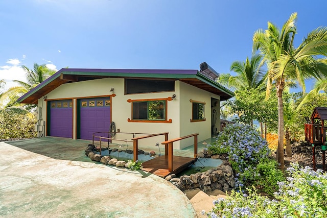 87-287 Kaohe Rd, Captain Cook, HI 96704 - view of front facade featuring driveway, stucco siding, and a garage