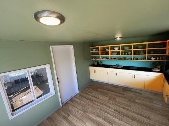92-8305 Mamalahoa Hwy, Ocean View, HI 96737 - kitchen with wood finished floors, open shelves, and a sink