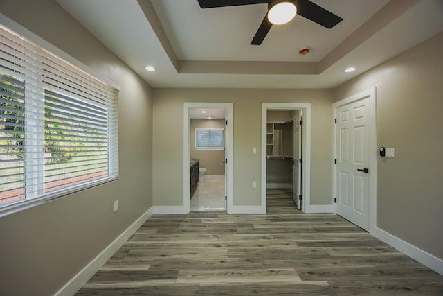 15-1779 14th Ave, Keaau, HI 96749 - unfurnished bedroom with a walk in closet, ensuite bathroom, a tray ceiling, baseboards, and recessed lighting