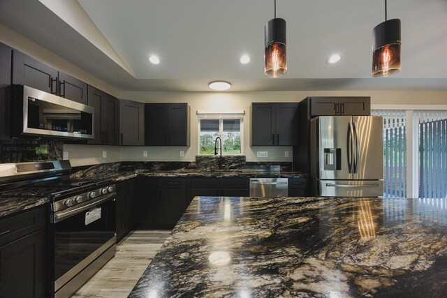 15-1779 14th Ave, Keaau, HI 96749 - kitchen with appliances with stainless steel finishes, dark stone countertops, a sink, pendant lighting, and vaulted ceiling