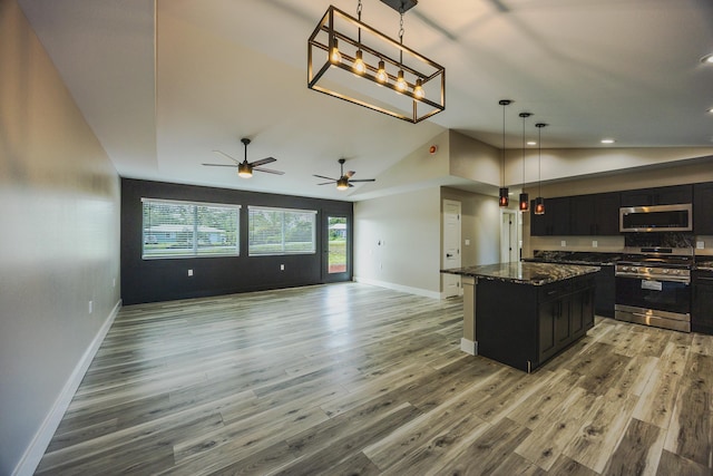 15-1779 14th Ave, Keaau, HI 96749 - kitchen featuring appliances with stainless steel finishes, dark cabinetry, open floor plan, baseboards, and light wood-style floors