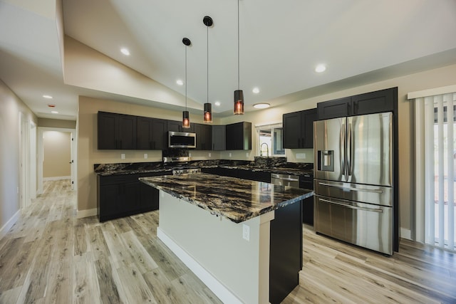 15-1779 14th Ave, Keaau, HI 96749 - kitchen featuring stainless steel appliances, light wood-type flooring, dark stone countertops, dark cabinetry, and vaulted ceiling