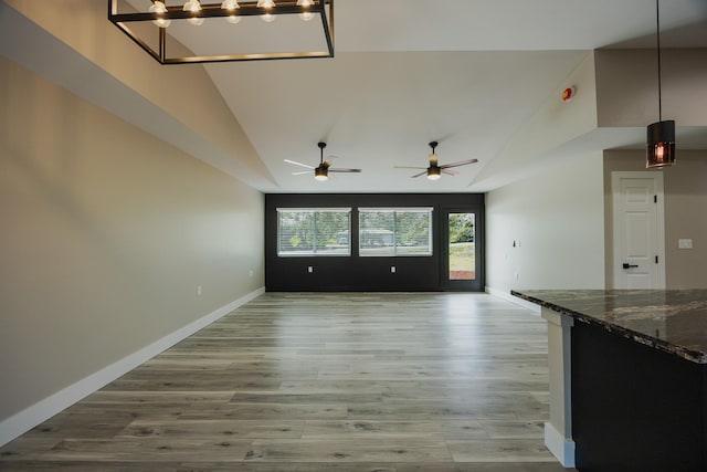 15-1779 14th Ave, Keaau, HI 96749 - unfurnished living room featuring vaulted ceiling, wood finished floors, baseboards, and a ceiling fan