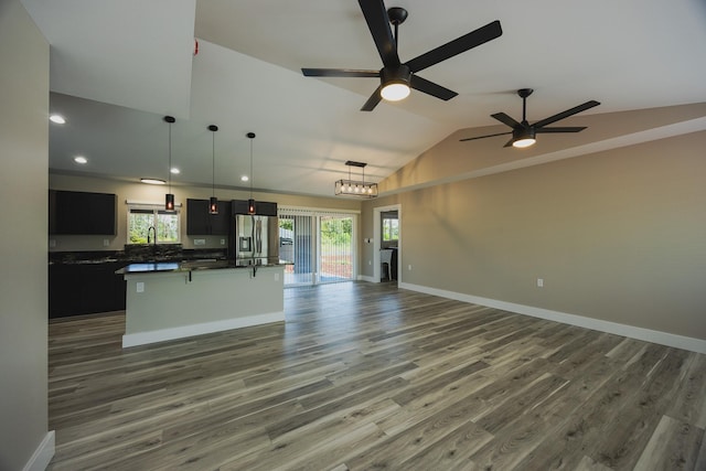 15-1779 14th Ave, Keaau, HI 96749 - unfurnished living room featuring plenty of natural light, vaulted ceiling, wood finished floors, a ceiling fan, and recessed lighting