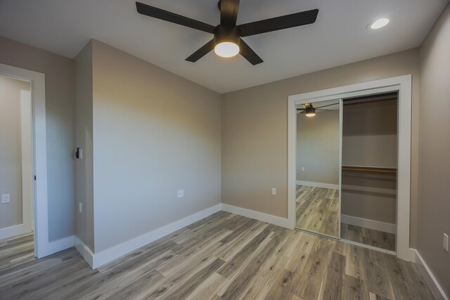 15-1779 14th Ave, Keaau, HI 96749 - unfurnished bedroom with wood finished floors, a closet, a ceiling fan, baseboards, and recessed lighting