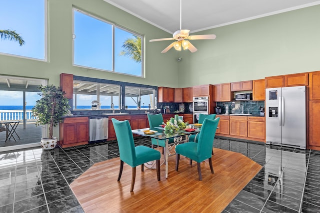 15-1023 Ala Heiau Rd, Keaau, HI 96749 - dining space with a towering ceiling, a ceiling fan, and crown molding
