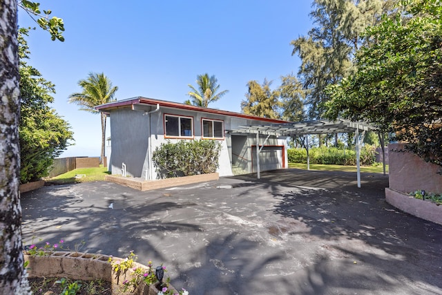 15-1023 Ala Heiau Rd, Keaau, HI 96749 - view of front of property with driveway, an outbuilding, an attached garage, and a pergola