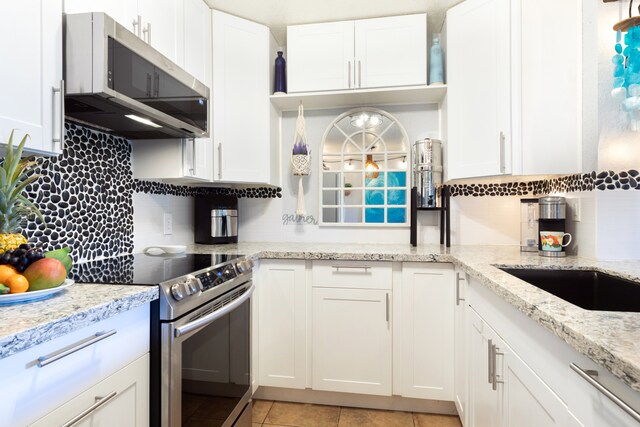 68-3890 Lua Kula St Unit 1007, Waikoloa, HI 96738 - kitchen featuring stainless steel appliances, white cabinetry, and decorative backsplash