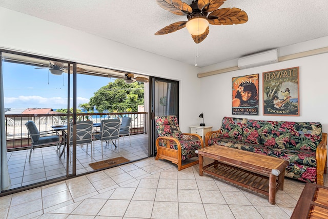 75-5719 Kona Plz Unit 203, Kailua-Kona, HI 96740 - living area featuring a wall unit AC, a textured ceiling, light tile patterned flooring, and a ceiling fan