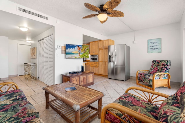 75-5719 Kona Plz Unit 203, Kailua-Kona, HI 96740 - living room with light tile patterned floors, a ceiling fan, and a textured ceiling
