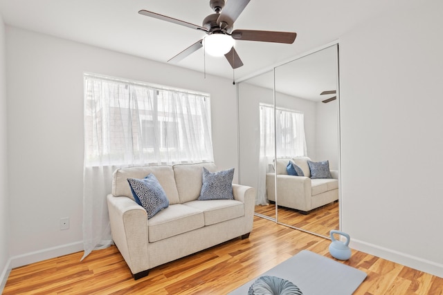 75-6081 Alii Dr Unit V106, Kailua-Kona, HI 96740 - living area with a ceiling fan, wood finished floors, and baseboards