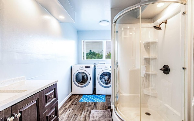 15-1688 18th Ave, Maia Keaau, HI 96749 - bathroom featuring washing machine and clothes dryer, a stall shower, wood finished floors, vanity, and baseboards