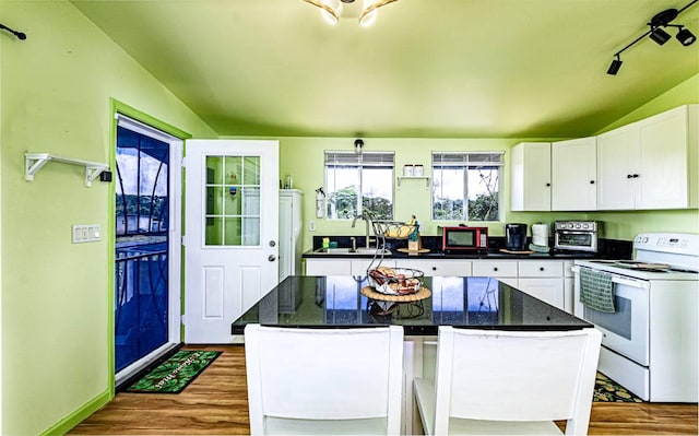 15-1688 18th Ave, Maia Keaau, HI 96749 - kitchen featuring white electric range, vaulted ceiling, dark wood-style floors, a sink, and white cabinets