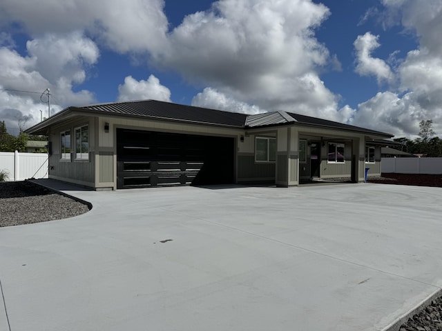 16-2102 Jewel Dr, Pahoa, HI 96778 - view of front of home featuring a garage, concrete driveway, a metal roof, and a standing seam roof