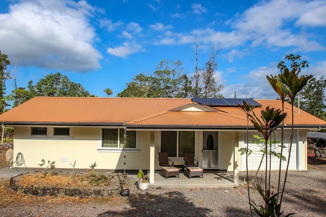16-380 Melekule St, Kurtistown, HI 96760 - rear view of property featuring solar panels, stucco siding, and metal roof