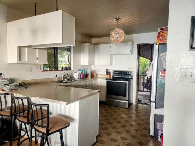 87-3207 Carissa Rd, Captain Cook, HI 96704 - kitchen with appliances with stainless steel finishes, a peninsula, a sink, white cabinetry, and pendant lighting