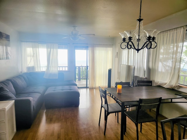 87-3207 Carissa Rd, Captain Cook, HI 96704 - dining space featuring healthy amount of natural light, ceiling fan, wood finished floors, and a chandelier