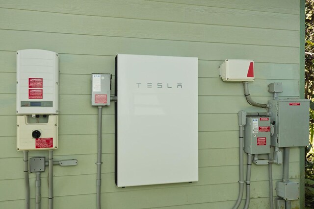 13-3571 Pomaikai St, Pahoa, HI 96778 - exterior view of wall-mounted power storage and related energy utilities