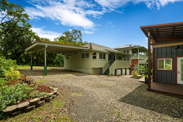 6450 Olohena Rd, Kapaa, HI 96746 - rear view of property with a carport, driveway, board and batten siding, and a shingled roof