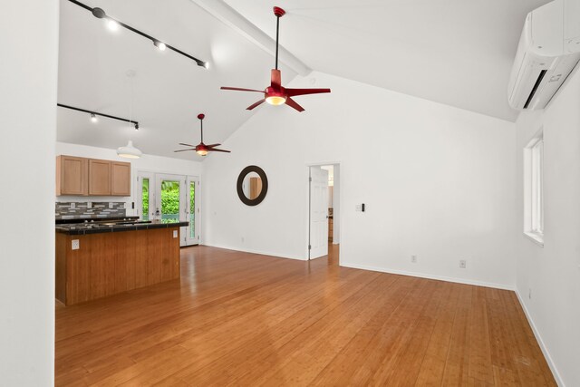 6450 Olohena Rd, Kapaa, HI 96746 - unfurnished living room with rail lighting, a ceiling fan, a wall mounted air conditioner, beamed ceiling, and light wood finished floors