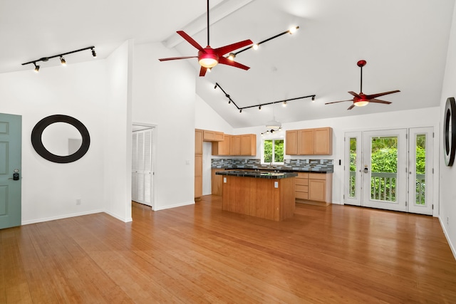 6450 Olohena Rd, Kapaa, HI 96746 - kitchen with a ceiling fan, rail lighting, dark countertops, a center island, and high vaulted ceiling