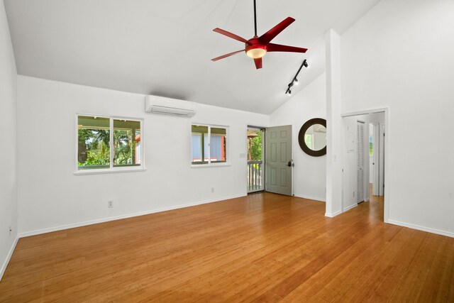 6450 Olohena Rd, Kapaa, HI 96746 - empty room featuring a wall mounted air conditioner, healthy amount of natural light, a ceiling fan, light wood finished floors, and high vaulted ceiling