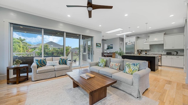2344 Halalii Pl, Koloa, HI 96756 - living room featuring light wood finished floors, recessed lighting, ceiling fan, a skylight, and ornamental molding
