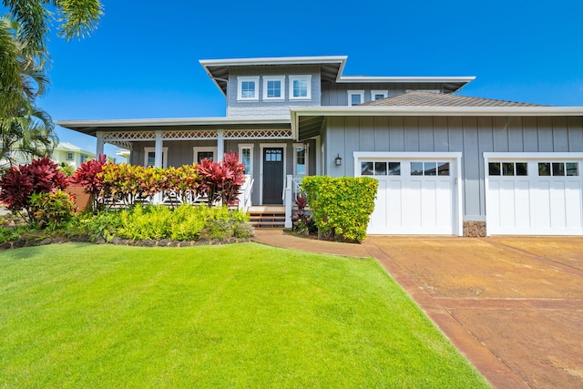 2344 Halalii Pl, Koloa, HI 96756 - view of front of house with driveway, a garage, board and batten siding, a front lawn, and covered porch