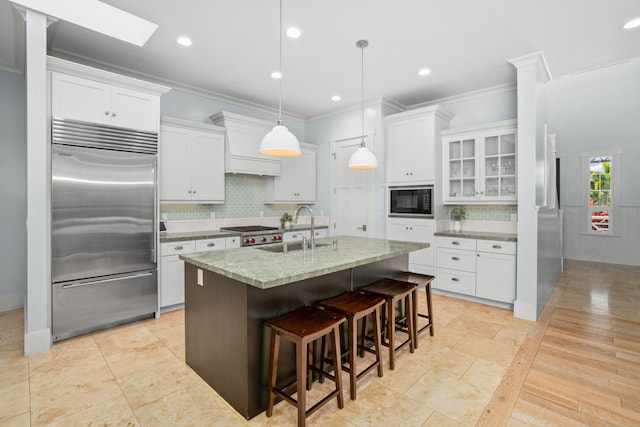 2344 Halalii Pl, Koloa, HI 96756 - kitchen with built in appliances, a sink, crown molding, tasteful backsplash, and white cabinetry