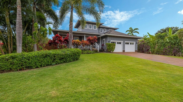 2344 Halalii Pl, Koloa, HI 96756 - traditional home with board and batten siding, a garage, concrete driveway, and a front yard