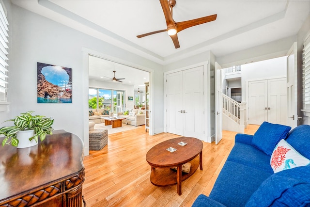 2344 Halalii Pl, Koloa, HI 96756 - living room featuring a ceiling fan, light wood finished floors, and stairs