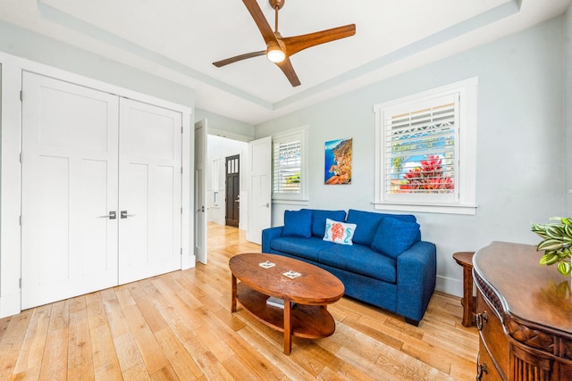 2344 Halalii Pl, Koloa, HI 96756 - living room featuring light wood-style floors, a raised ceiling, ceiling fan, and baseboards