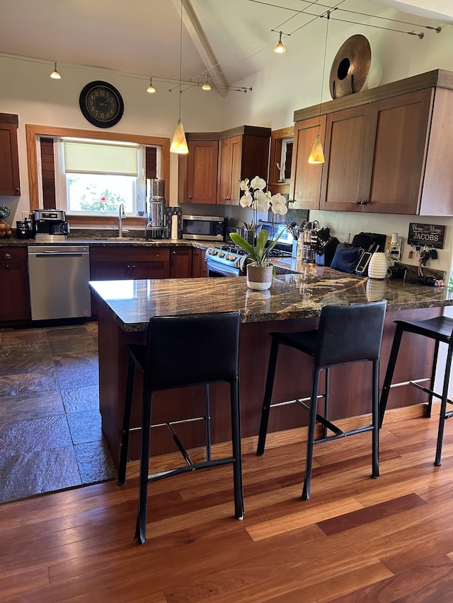 6670-G Kahuna Rd Unit 2, Kapaa, HI 96746 - kitchen featuring appliances with stainless steel finishes, a peninsula, rail lighting, and decorative light fixtures