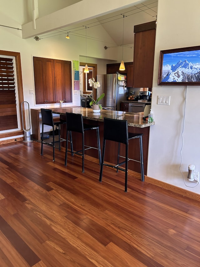 6670-G Kahuna Rd Unit 2, Kapaa, HI 96746 - kitchen with freestanding refrigerator, a kitchen bar, dark wood-style flooring, and high vaulted ceiling