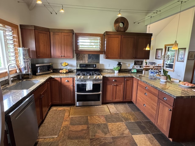 6670-G Kahuna Rd Unit 2, Kapaa, HI 96746 - kitchen with appliances with stainless steel finishes, a peninsula, rail lighting, stone countertops, and dark stone finish floors