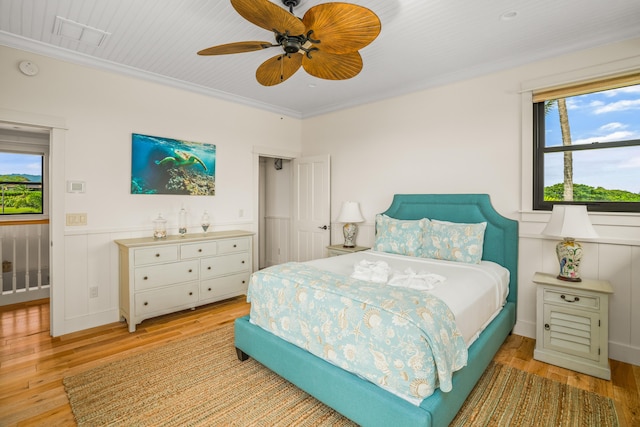 2739 Uluwehi St, Koloa, HI 96756 - bedroom with multiple windows, light wood-style floors, crown molding, and ceiling fan