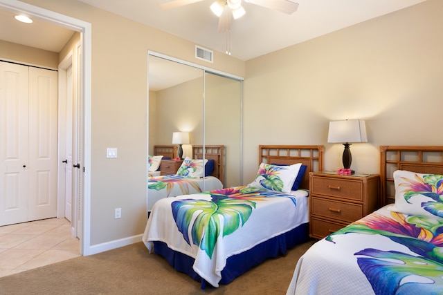 68-180 Waikoloa Beach Dr Unit J1, Waikoloa, HI 96738 - tiled bedroom featuring carpet, baseboards, ceiling fan, and a closet