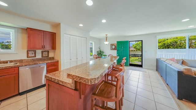 3780 Edward Rd Unit 5301, Princeville, HI 96722 - kitchen featuring dishwasher, a kitchen bar, open floor plan, recessed lighting, and light tile patterned floors
