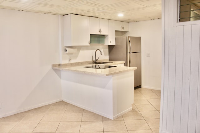 75-5719 Kona Plz Unit 119, Kailua-Kona, HI 96740 - kitchen featuring white cabinets, a sink, freestanding refrigerator, light tile patterned floors, and baseboards