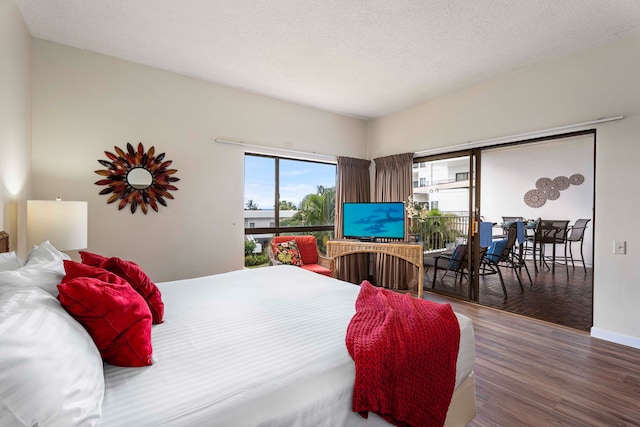 75-6040 Alii Dr Unit 504, Kailua-Kona, HI 96740 - bedroom with wood finished floors, access to outside, baseboards, and a textured ceiling