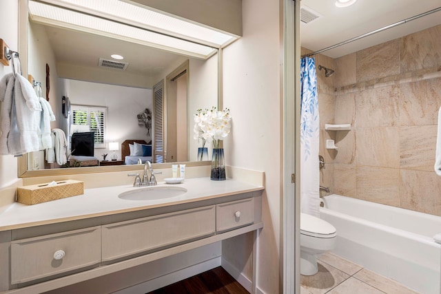 75-6040 Alii Dr Unit 504, Kailua-Kona, HI 96740 - ensuite bathroom featuring toilet, vanity, shower / bath combo with shower curtain, and tile patterned floors