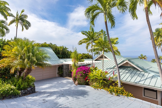 78-6846 Keaupuni St, Kailua-Kona, HI 96740 - view of home's exterior with a standing seam roof, driveway, and metal roof