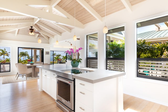 78-6846 Keaupuni St, Kailua-Kona, HI 96740 - kitchen with stainless steel range with electric cooktop, light wood finished floors, hanging light fixtures, white cabinets, and light countertops