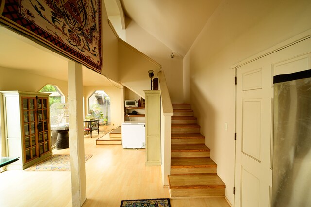 2239 Upper Kanaio Rd, Kula, HI 96790 - stairway with wood finished floors and vaulted ceiling