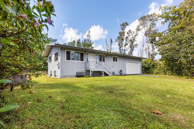 15-2042 14th Ave, Keaau, HI 96749 - back of property with a lawn and an attached garage
