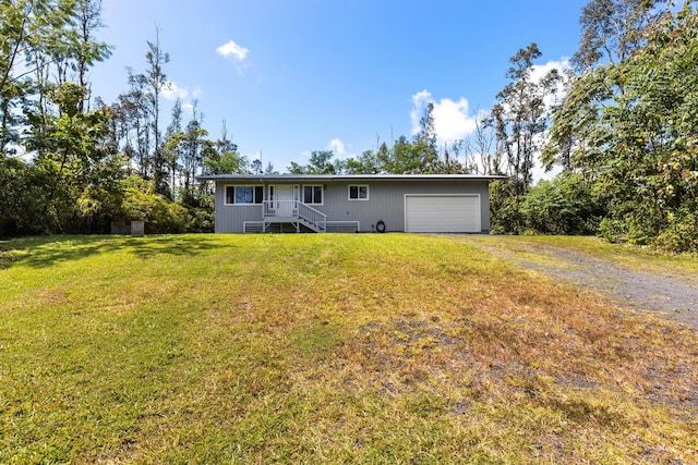 15-2042 14th Ave, Keaau, HI 96749 - rear view of house featuring dirt driveway, a yard, and an attached garage