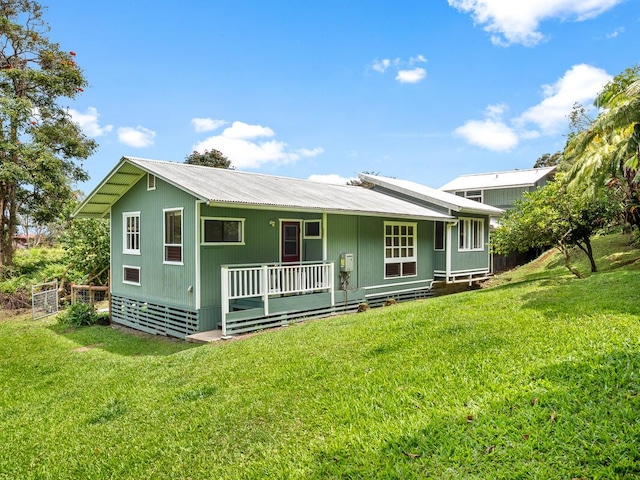 1174 Ainalako Rd, Hilo, HI 96720 - view of front of house with a front yard and metal roof